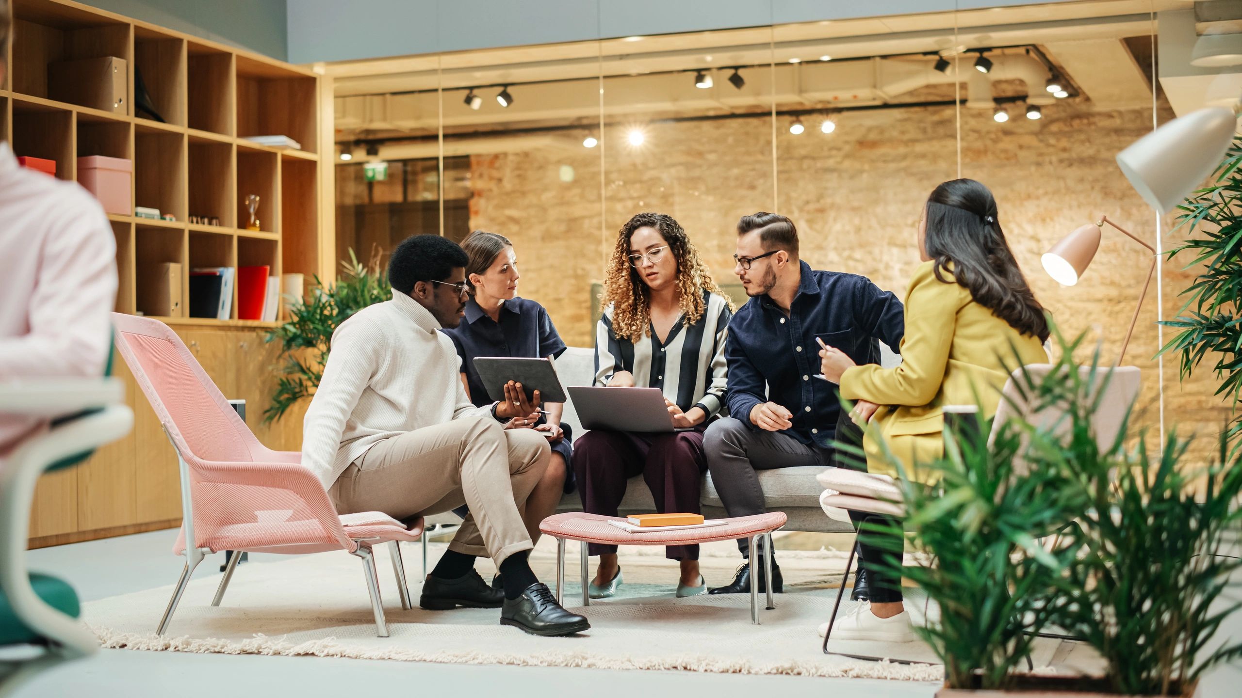 Multiethnic creative team discussing ideas in a modern meeting room